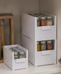 Versatile Big Capacity Heavy Duty Stackable Storage Bins Open Top Space Saving Closet Organizer With Slick Zero Hassle Design For Bedroom Bathroom And Kitchen Game Changer holding spice jars in a kitchen cabinet.