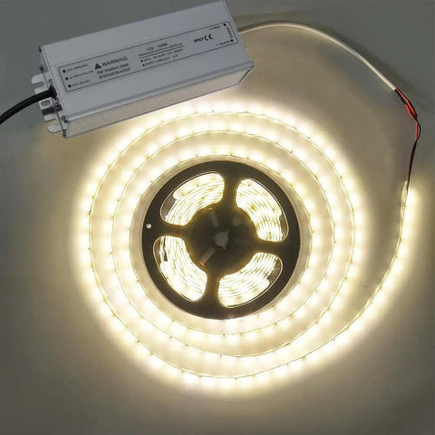 All Weather 100W 12V DC LED Driver Power Supply IP67 Waterproof Outdoor Transformer next to illuminated LED strip