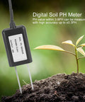 Close-up of a digital Soil pH Sensor with RS485 0 to 5V 0 to 10V and 4 to 20mA outputs in soil near a seedling, IP68 waterproof.