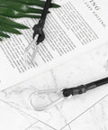 Close-up of black polyester luggage straps with metal carabiner hooks, part of Four Pack Elastic Luggage Straps With Carabiner Hooks Black.