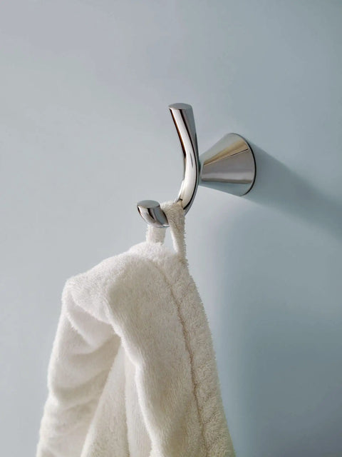 Glyde Brushed Nickel Wall Mount Robe Hook For Bathroom Towel And Bath Robe With Pro-Fit Easy Install and template coordinates with Genta Collection. A towel is hanging on the hook.