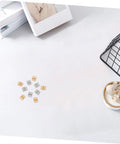 Copper Mini Hinges For Craft Projects And Jewelry Boxes, 100 Pack displayed on a white surface with decor items nearby