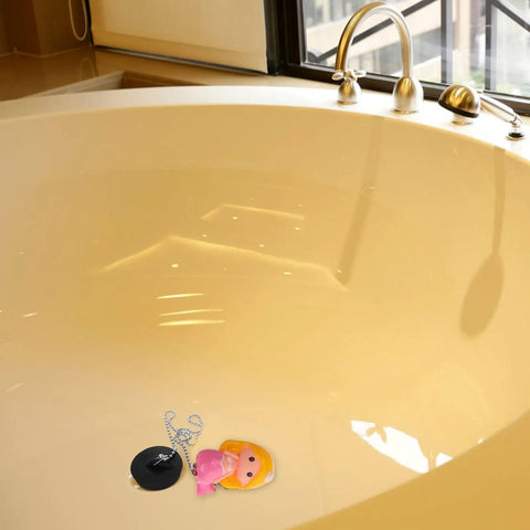 Mermaid Bathtub Stopper Plug Rubber Drain Seal with Chain resting in a beige bathtub, featuring a pink mermaid design and shiny chain.
