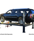 Top Shelf Four Post Vehicle Parking Lift With Massive Eight Thousand Pound Load Capacity and Heavy Duty Diamond Plate Runways For Your Weekend Wrencher Shop with SUV raised