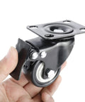 8 Pack 2 Inch Heavy Duty Swivel Plate Caster Wheels With Double Brake And PU Foam No Noise For Furniture Tables Trolleys Workbenches And Garage Use Each Caster Supports Up To 150 Lbs Durable Top Plate With Double Ball Bearing For Smooth Quiet Rolling, close-up view in hand