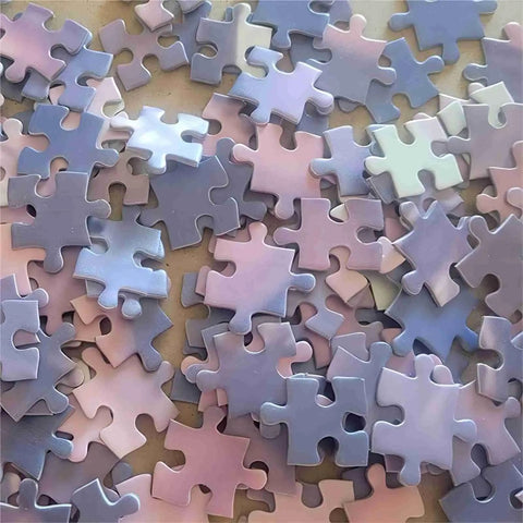Scattered pieces of a Blank Sublimation Jigsaw Puzzle Set 45 Pieces 8 By 11 Inches Heat Press Ready For DIY Projects Weddings Decor Family Activities.