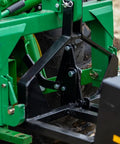Close-up of 3 Point 10 Cu Ft Dump Box with quick hitch on Category 1 tractor showing rear self dumping mechanism.