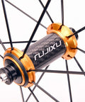 Close-up of 700C Carbon Hub Wheelset for Road Bikes with Aluminum Rim, showcasing gold-colored hub and black spokes.