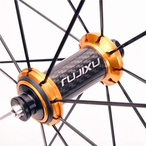 Close-up of 700C Carbon Hub Wheelset for Road Bikes with Aluminum Rim, showcasing gold-colored hub and black spokes.