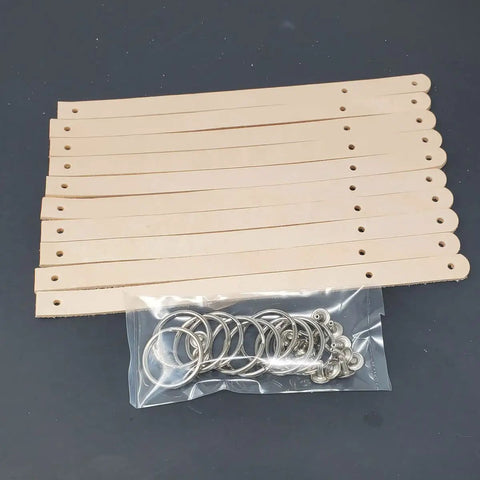 Ten Pack Of One Half Inch Natural Vegetable Tanned Leather Keychain Blanks Ready For Custom Stamping And Tooling on a black background.