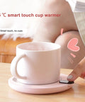 Keep Your Daily Brew On Lock With This Sleek Pink USB Coffee Mug Warmer That Slaps With Three Custom Heat Levels And A Smart Hydration Reminder For Top Shelf Home Office Vibes - pink USB cup warmer with touch control.
