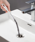 Heavy Duty Flexible Drain Snake Brush For Kicking Clogged Sink And Tub Pipes Clear, reusable tool clearing hair in sink.