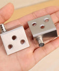 Easy Install Stainless Steel Hidden Right Angle Hinge For Cupboard And Cabinet Doors Rotatable With Screws Includes 2 Pack Of Hardware Fittings In Silver Finish 35 By 32.5 Mm, shown resting on an open palm.