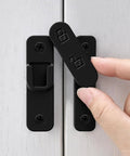 Sturdy Black Zinc Alloy Barn Door Latch With 180 Degree Slide Lock For Wood Doors, hand adjusting the lock mechanism.