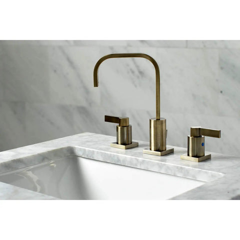 Antique Brass Widespread Bathroom Faucet With Drip Free Ceramic Disc Cartridge Deck Mount Eight To Sixteen Inch Three Hole Installation One Point Two GPM Flow At Sixty Psi One Half Inch IPS Connection Classic Modern Blend installed on marble countertop.