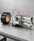 Heavy Duty Pneumatic Strapping Tool 3500 N Tension Automatic Banding Machine on a table with black strap roll.
