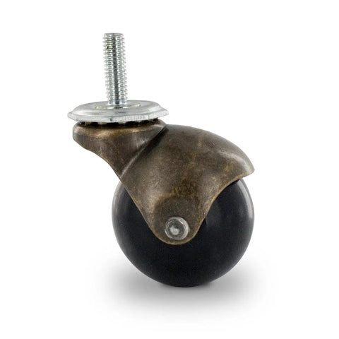 Close-up view of antique brass PVC ball caster with swivel hooded design and 5/16-18 thread for furniture gear.
