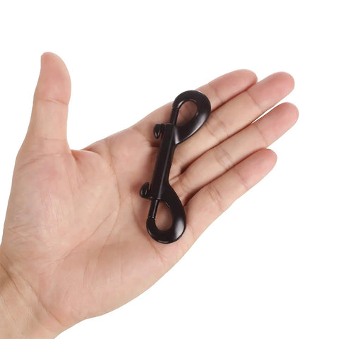 In-hand view of a black metal double-ended bolt snap hook (3.5 in long)