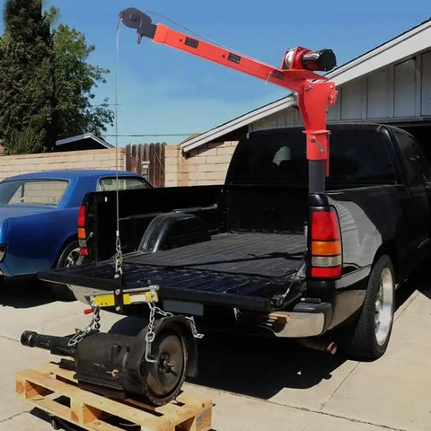 Heavy Duty Folding Truck Mounted Bed Crane Hoist With 4000 Lb Payload 12V Electric Winch lifting a transmission in a pickup truck.