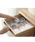 Keep Your Closet Chill With This Four Piece Sock And Underwear Storage Box Featuring Smooth Slide Compartments For Taming Piles And Sorting Gear With Ease showing organized gray socks in a drawer.