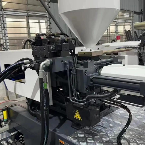 Close-up of Top Shelf Automatic Hydraulic Injection Molding Machine For Folding Plastic Chairs And Home Accessories showing hydraulic lines.