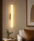 JCQASRT 19.69 in Modern Wall Sconce on a wall, featuring a warm resin shade and polished brass base in cozy living room setting.