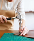 Person using Eight Size Leather Oval Hole Punch Kit 2mm To 5mm Pro Grade Hollow Punch Tool Set on leather craft project