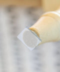 Close-up of a chair leg with Eight Pack Non Slip Silicone Furniture Feet Pads For Chair Legs And Home Furniture, transparent design.