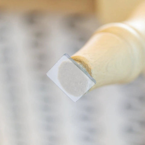 Close-up of a chair leg with Eight Pack Non Slip Silicone Furniture Feet Pads For Chair Legs And Home Furniture, transparent design.