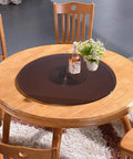 Big Time Tempered Glass Lazy Susan Solid Round Swivel Turntable Top Shelf with bottle and flowers on wooden dining table.
