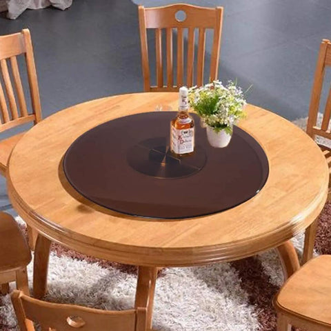 Big Time Tempered Glass Lazy Susan Solid Round Swivel Turntable Top Shelf with bottle and flowers on wooden dining table.