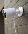 Two Pack Outdoor Security Camera Set 1080p Waterproof WiFi Smart Cams With Night Vision Motion Alerts Cloud Storage Smartphone App Alexa Compatible Front Door Surveillance System mounted on brick wall