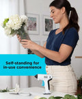 Woman arranging flowers next to 4V MAX Cordless Glue Gun USB Rechargeable Quick Heat Up In 30 Seconds Stand Up Base