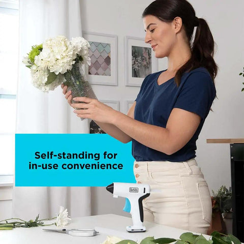 Woman arranging flowers next to 4V MAX Cordless Glue Gun USB Rechargeable Quick Heat Up In 30 Seconds Stand Up Base