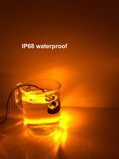 50 Pcs Three Quarter Inch Amber LED Marker Lights Kit submerged in water showing waterproof feature, glowing amber