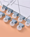 Six Piece Pack Of One Inch Universal Furniture Casters In Bright White Impact Resistant Nylon with silver plates on a flat surface.
