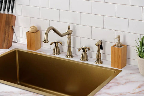 French Country Widespread Kitchen Faucet With Brass Sprayer in Oil Rubbed Bronze installed over a gold sink