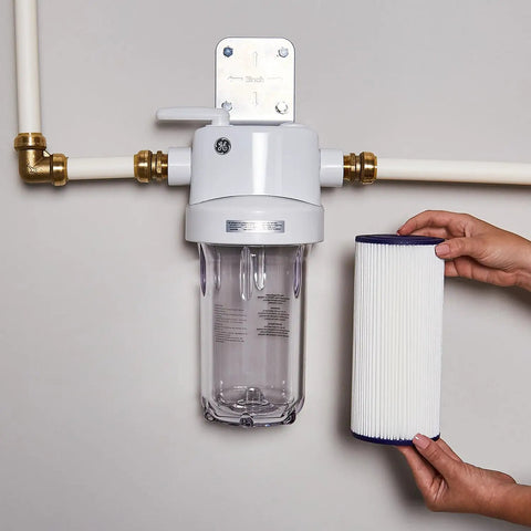 Whole House Water Filter Replacement For Home Filtration System NSF Certified To Reduce Chlorine Taste And Odor, Sediment, Rust And Impurities 10 Inch 4.5 Inch Filter Compatible With GXWH40L GXWH30C GXWH35F GXWH38F GNQH38S Replace Every 3 Months shown with filter housing installed on pipes.