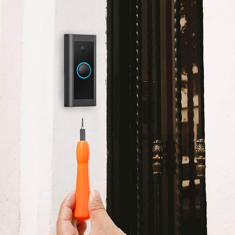 Hand using Torx T6 T15 Double End Doorbell Screwdriver For Ring Replacement And Installation near doorbell on wall