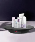 Smooth Electric Rotating Display Stand 360 Degree Turntable With Pure Copper Motor showcasing cosmetic bottles on a sleek base.