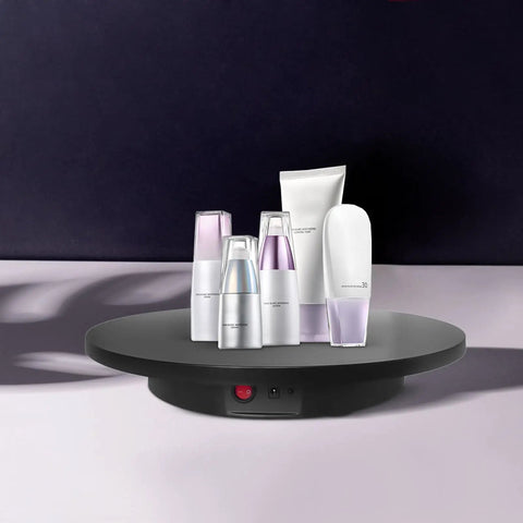 Smooth Electric Rotating Display Stand 360 Degree Turntable With Pure Copper Motor showcasing cosmetic bottles on a sleek base.