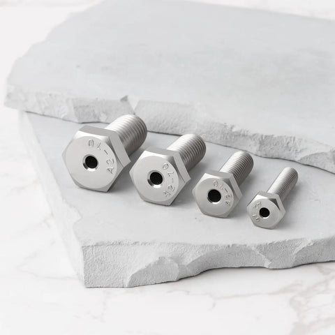 Pro Grade 4 Piece Heavy Duty Stainless Steel Busted Stud Drill Guide Kit M6 M8 M10 M12 screws displayed on a marble surface.