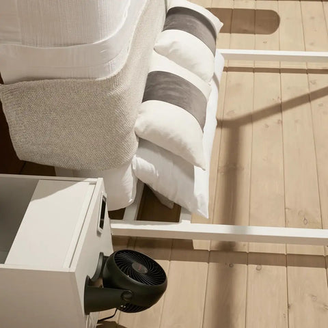 TurboForce Air Circulator Table Fan with 3 Speeds and 90 Degree Pivot in a bedroom setting, compact desk or floor unit for cooling.