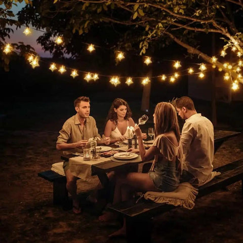 33 Ft 100 LED Star Fairy String Lights With Remote And Timer For Indoor And Outdoor Use Warm White Waterproof Decor illuminating an outdoor dinner