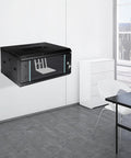 Heavy Duty 4U Wall Mount Server Rack Cabinet Built Tough For Network Switches And IT Gear, black with glass door in office setting.