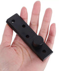 Black 360 Degree Stainless Steel Pivot Hinge for Invisible Doors in hand, showing concealed design for bookcases and secret doors.