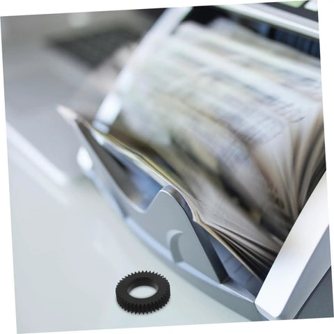 Close-up of Six Piece Counting Machine Gear Wheel for Currency Counter Replacement in use beside a money counting machine.