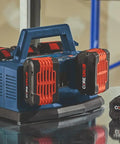 Ultra Fast 18V 6-Bay Battery Charger With 8 Amp Charge Delivers 80 Percent In 32 Minutes And 100 Percent In 50 Minutes, Sequentially Powers Six 18V Batteries For Back-To-Back Jobs, shown on workshop table with batteries