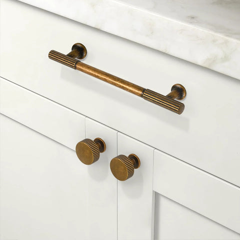 Antique Brass Kitchen Cabinet Knobs 10 Pack Zinc Drawer Pulls installed on white cabinets in kitchen