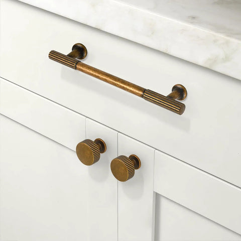 Rustic Antique Brass Drawer Pulls And Cabinet Knobs 2 Pack Solid Zinc Handles on white cabinet with marble top.